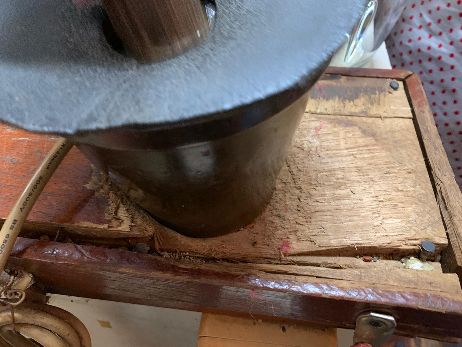 The well-worn solid wood base of the pestle and mortar.